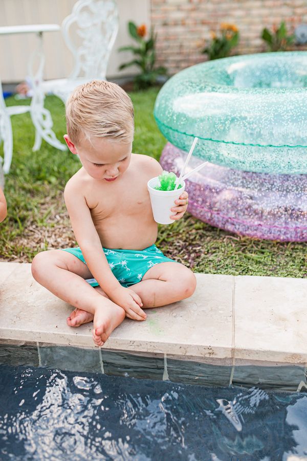 Kid enjoying Snow-La-Lah snowball at pool party