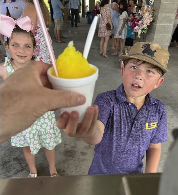 Kids being served fresh snowballs at event