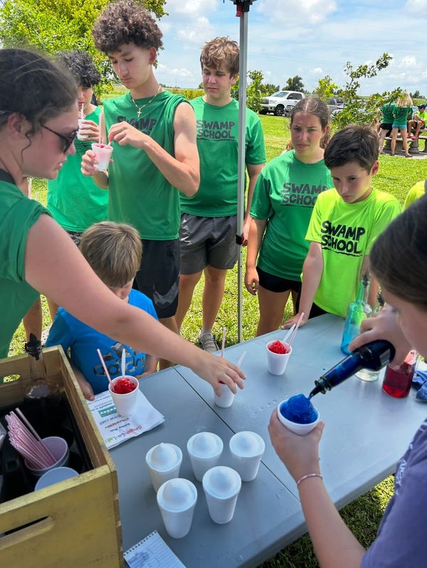 Swamp School students enjoying Snow-La-Lah snowballs