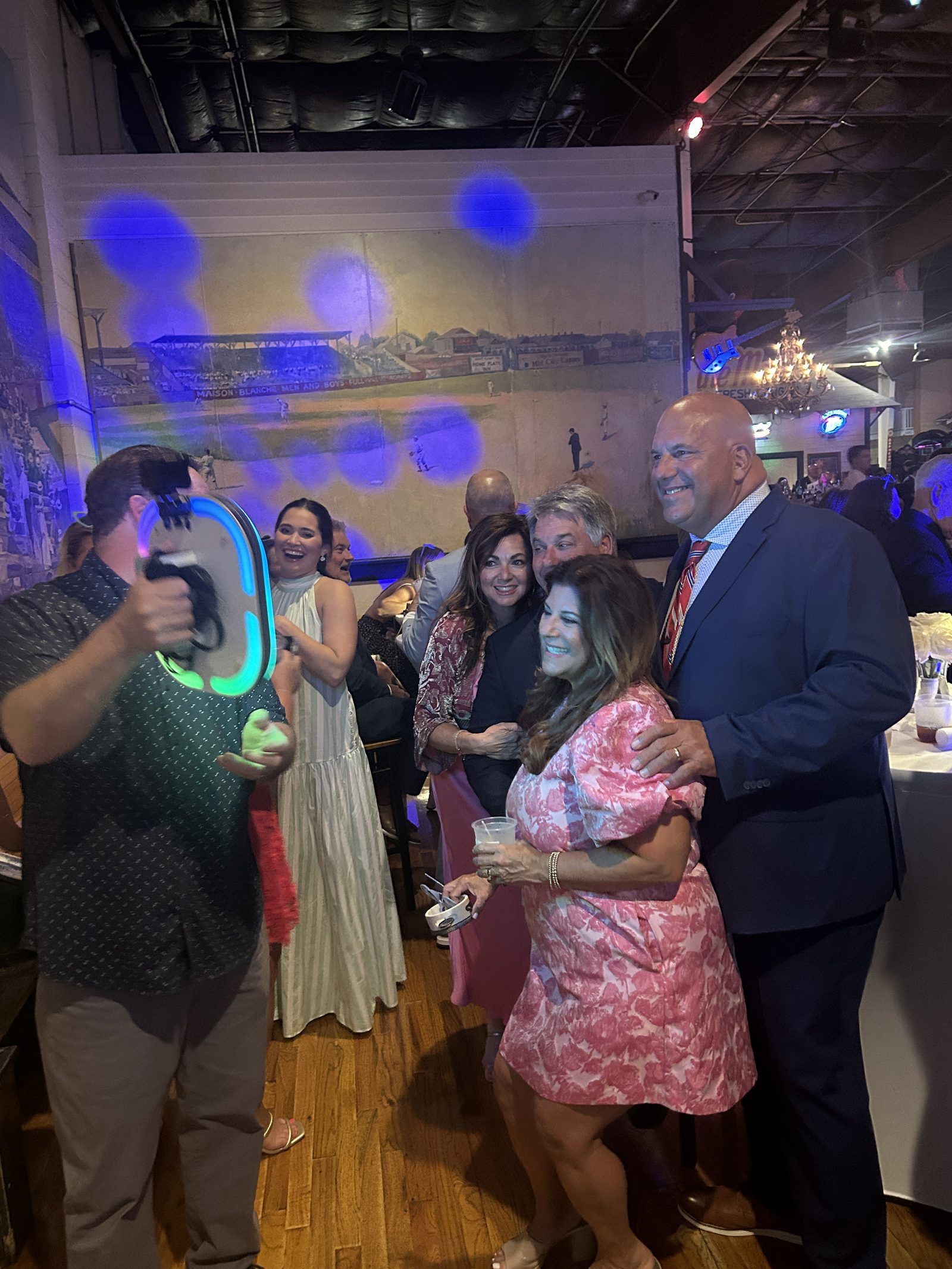 Guests posing with the Ramblin' Roamer roaming photo booth at a New Orleans gala