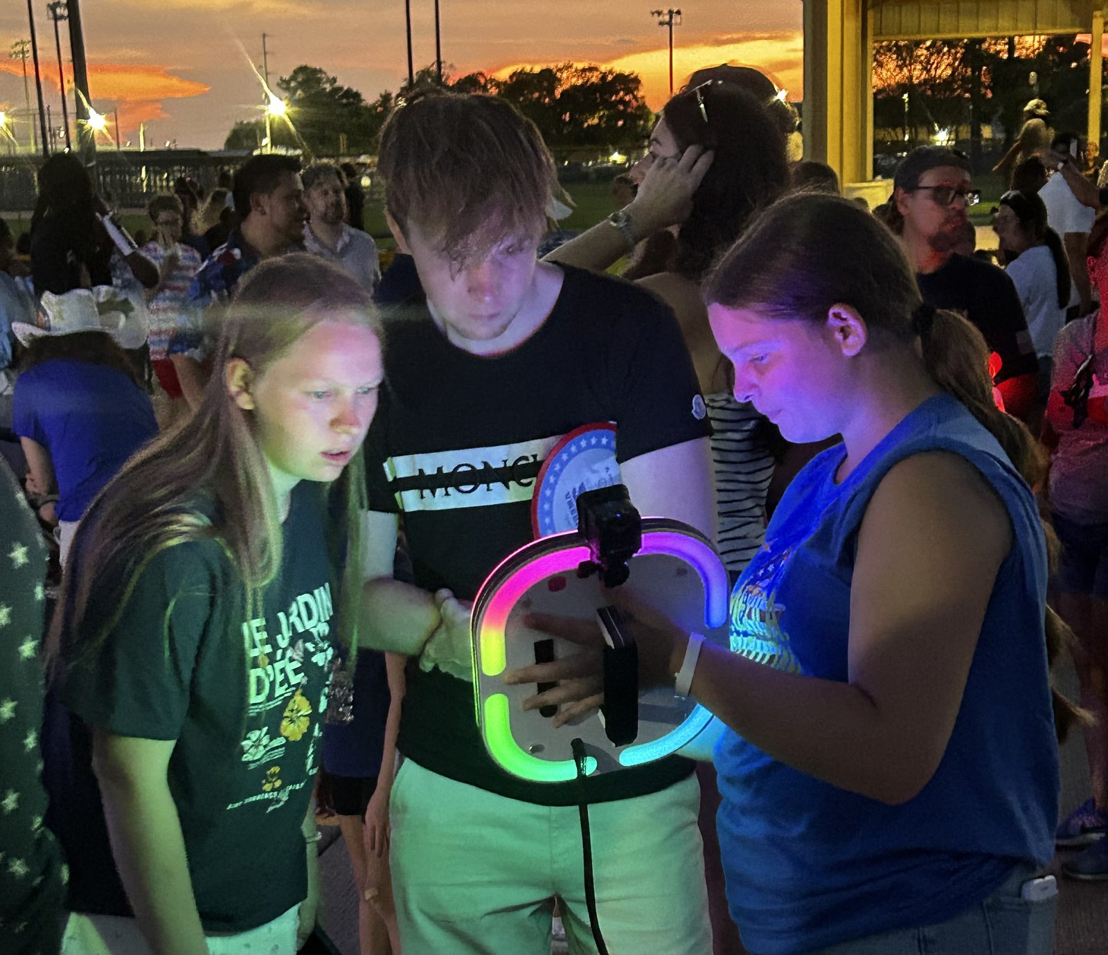 Guests using the Ramblin' Roamer mobile photo booth at an outdoor evening event in New Orleans